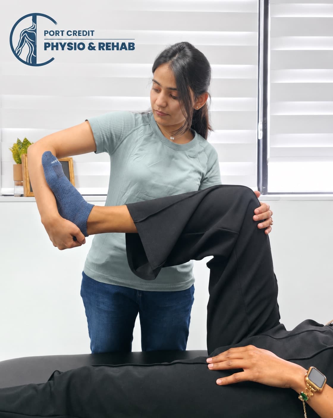 Physiotherapist assessing a runner's knee and hip mobility during a sports injury consultation at Port Credit Physio & Rehab, Mississauga